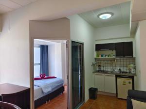 a small room with a bed and a kitchen at Avatara A Ocean Views by malai in Ban Tha Fat