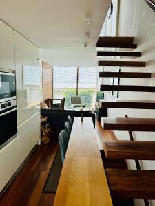 a living room with a staircase with a couch and a table at Casa dos Coelhos in Moledo