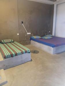 two twin beds in a room with a wall at Ocean beach in Galle