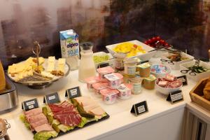 a buffet with different types of food on a table at Urban Bivouac Hotel in Paris +39 photos