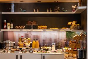 a bakery counter with various pastries and other food items at Urban Bivouac Hotel in Paris