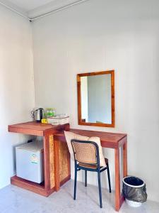 a wooden desk with a chair and a mirror at Book Lanta House in Ban Ru Yai +91 photos