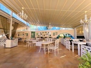 a restaurant with tables and chairs in a room at Бутиков хотел History in Haskovo