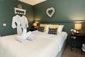 a bedroom with two beds with towels on them at Beth's Bothy in Gatehouse of Fleet