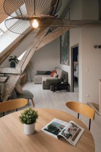 a living room with a table and a couch at La Ferme de la Gloriette - Gîte & Spa in Émines +13 photos