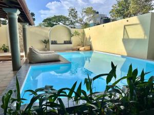 a swimming pool in the backyard of a house at Arco Mirissa in Mirissa
