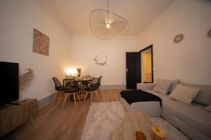 a living room with a couch and a table at L'Élégance - Cozy & Parking in Chambéry