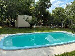 a blue swimming pool in a yard at Blanco Jazmines in Concepción del Uruguay