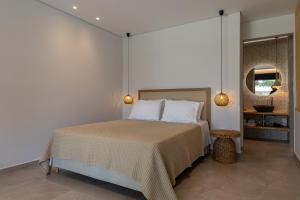 a bedroom with a bed and a mirror at Acacia - Explore your senses in Preveza +61 photos