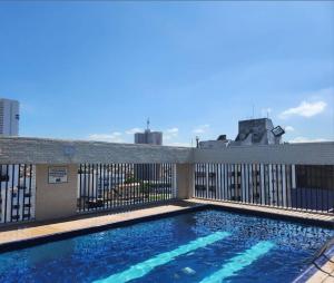 a swimming pool on top of a building at Prime Flat Palladium Mar & Piscina in São Vicente