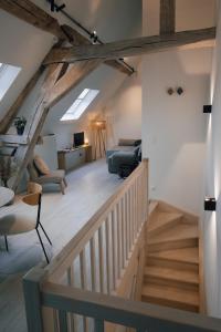 a room with a staircase and a living room at La Ferme de la Gloriette - Gîte & Spa in Émines