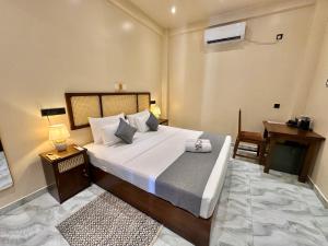 a bedroom with a large bed with a desk and a bed sidx sidx sidx at Arco Mirissa in Mirissa +32 photos