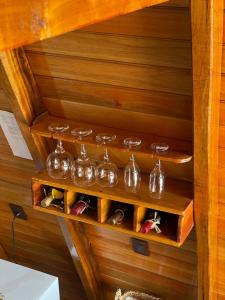 a row of wine glasses on a wooden wall at Chalé Fusinato in Witmarsum