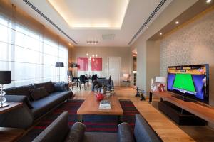 a living room with a large flat screen tv at Wyndham Ankara in Ankara