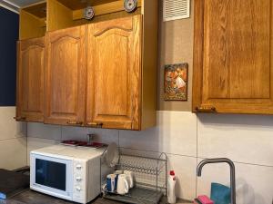 a kitchen with a microwave on top of a counter at K76 - Very Nice 2-bedrooms Apartment -2 big beds-1 single bed in Tartu