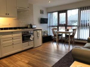 a kitchen and living room with a table and a dining room at Millbrook House Apartments 8 in Milton