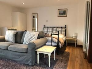 a living room with a couch and a bed at Millbrook House Apartments 8 in Milton