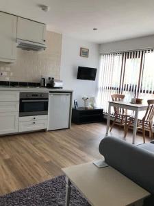 a kitchen and living room with a couch and a table at Millbrook House Apartments 8 in Milton