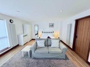 a living room with a couch and a bed at Millbrook House Apartments 9 in Milton