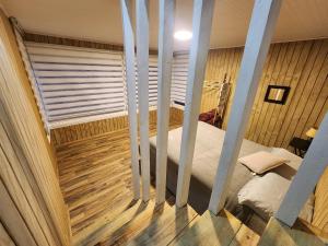 a bedroom with a bed and a wooden floor at Loft playaBlanca in Coronel +22 photos