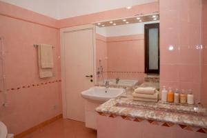 a pink bathroom with a sink and a mirror at Corina's Place Bologna Home in Bologna +32 photos
