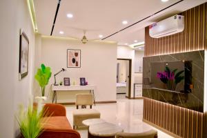 a living room with a couch and a table at Executive 2BHK in Zeta Mall in Islamabad
