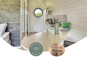 a kitchen with a counter in a tiny house at Dilham Hall Retreats in Dilham