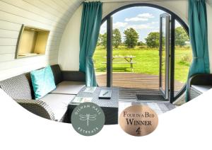 a screened in porch with a couch and a table at Dilham Hall Retreats in Dilham +8 photos
