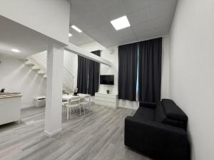 a living room with a black couch and a table at Viva Residence in Calderara di Reno