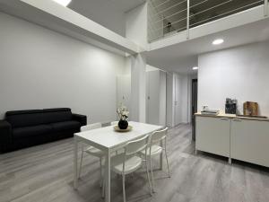 a kitchen and a dining room with a table and chairs at Viva Residence in Calderara di Reno +53 photos
