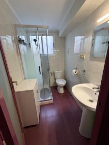 a bathroom with a shower and a toilet and a sink at RIU MAR Apartment Cullera in Cullera +6 photos
