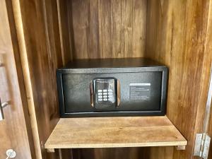 a cell phone in a box in a wooden cabinet at Arco Mirissa in Mirissa