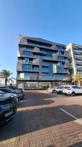 a parking lot with cars parked in front of a building at Eid Holiday in Muscat