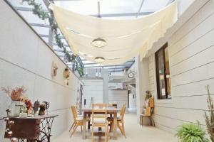 a dining room with a table and chairs and a ceiling at See U Tainan Apartment in Yongkang