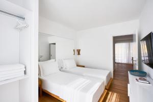 a white room with a bed and a television at Flamm Residences in Bodrum City +26 photos