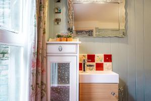 a bathroom with a sink and a mirror at Stoneywell Cottage - Elie in Elie +61 photos