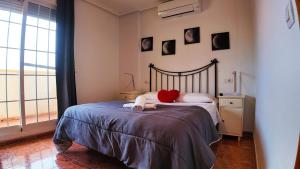 a bedroom with a bed with a red heart on it at Apartalux Playa Paraíso in La Manga del Mar Menor