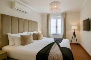 a bedroom with a large bed with white pillows at Solar Do Douro in Santa Cruz do Douro