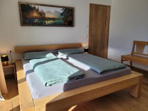 a bed with two pillows on it in a room at Ferienwohnung Obstgarten in Halblech