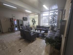 a large living room with couches and a table at Hostel Arena in Zagreb