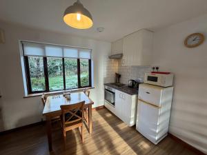 a small kitchen with a table and a microwave at Millbrook House Apartments 4 in Milton