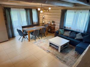 a living room with a blue couch and a table at PUTNI Resort in Laukbeitini
