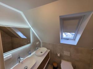 a bathroom with a sink and a toilet and a mirror at Handwerkerwohnung, Monteurunterkunft-Rodgau in Rodgau +201 photos