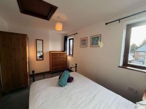 a bedroom with a white bed and a window at Millbrook House Apartments 3 in Milton