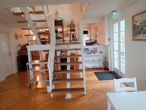 a white spiral staircase in a living room at Stege Nor in Stege