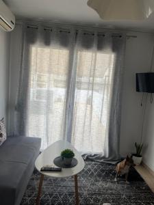 a living room with a couch and a table at ArMA URBAN LIVING in Bendevís +5 photos