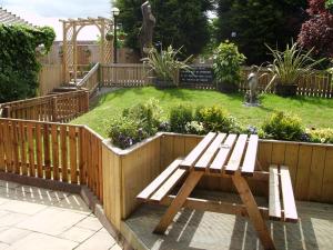 a wooden bench sitting in the middle of a garden at The Stockton Arms in Stockton-on-Tees