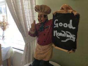 a statue of a chef holding a good restaurant sign at The Stockton Arms in Stockton-on-Tees