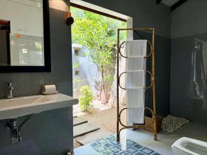 a bathroom with a sink and a toilet and a mirror at Dark Green Resort - Airport Transit Villa in Negombo