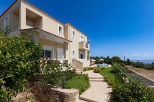 a house with a pathway leading up to it at Chios Seafront Luxury Villa with Pool in Chios